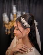 side headpiece made up of pearls and rhinestones and crystals
